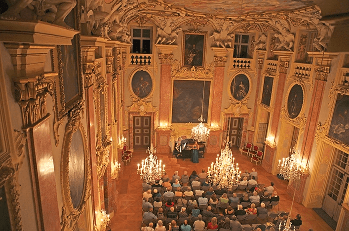Guests watching a performance inside the Rastatt Castle, Germany