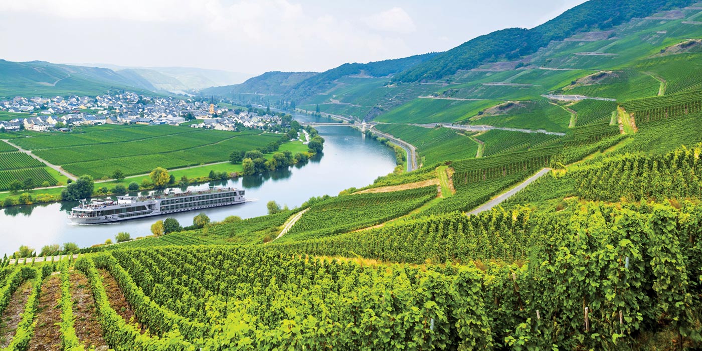 Scenic river ship in the Moselle River Valley surrounded by terraced vineyards