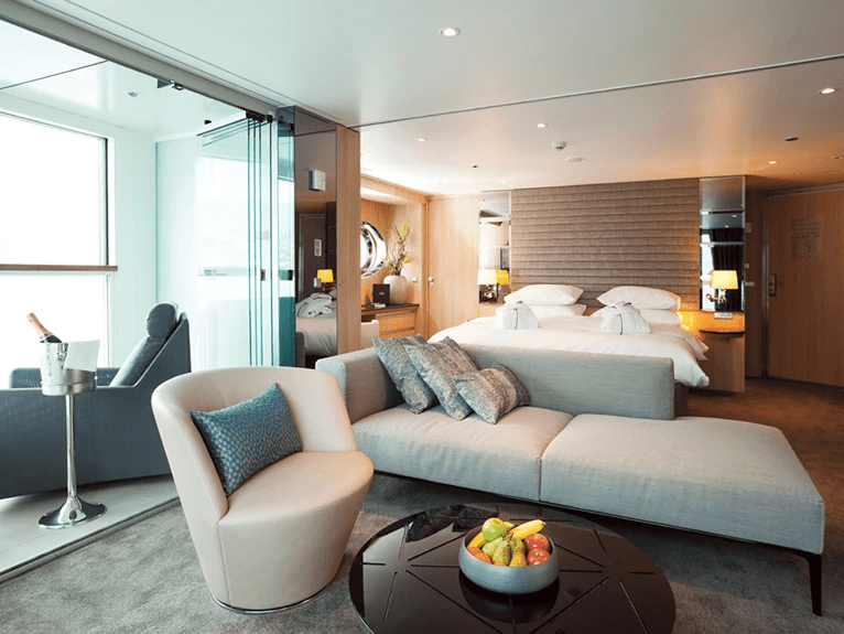 The luxurious lounge area and queen bed in the Royal Panorama Suite on the Scenic Jasper