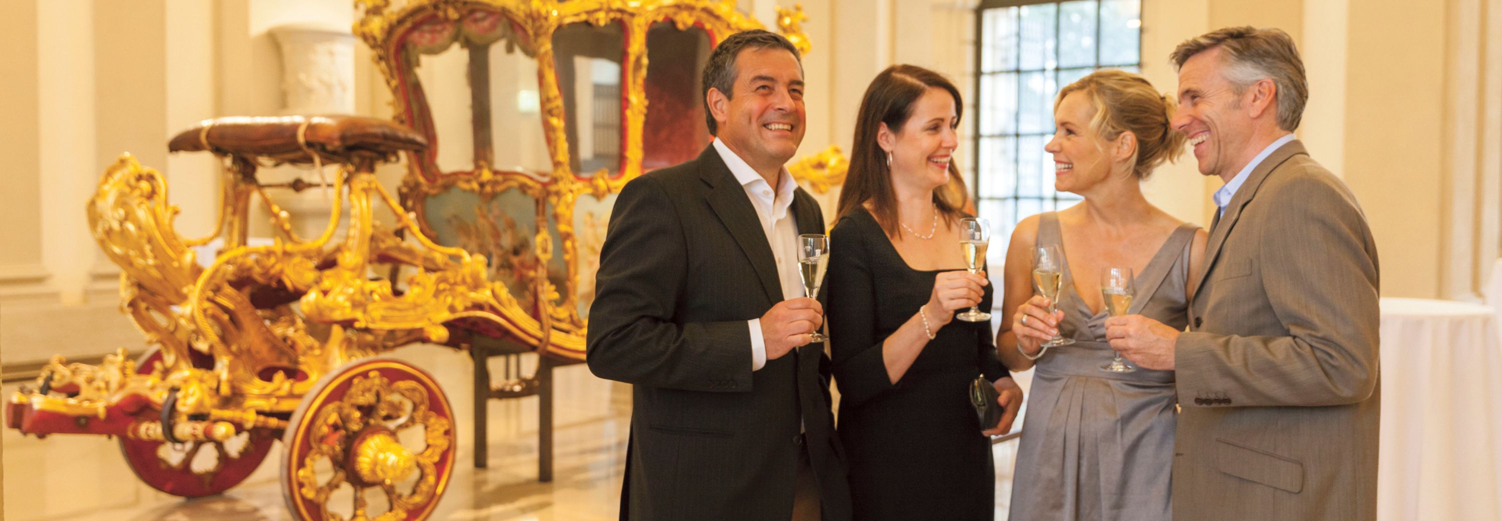 Two men and two women holding champagne at Palais Liechtenstein