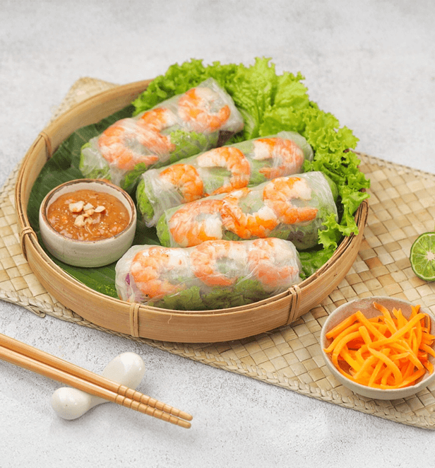 Fresh Vietnamese spring rolls with shrimp, lettuce, and herbs served with hoisin peanut dipping sauce.